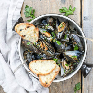 An overhead image of mussels with toast
