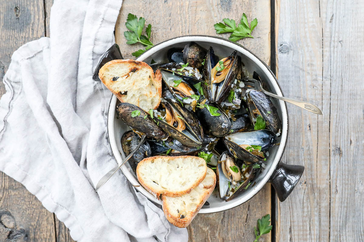 An overhead image of mussels with toast