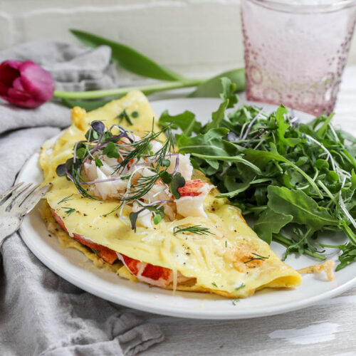 An image of a lobster omelette with arugula