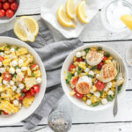 An image of a scallop, corn, tomato and basil salad
