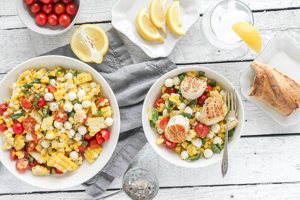 An image of a scallop, corn, tomato and basil salad