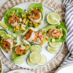 An overhead image of grilled shrimp lettuce wraps with corn salad