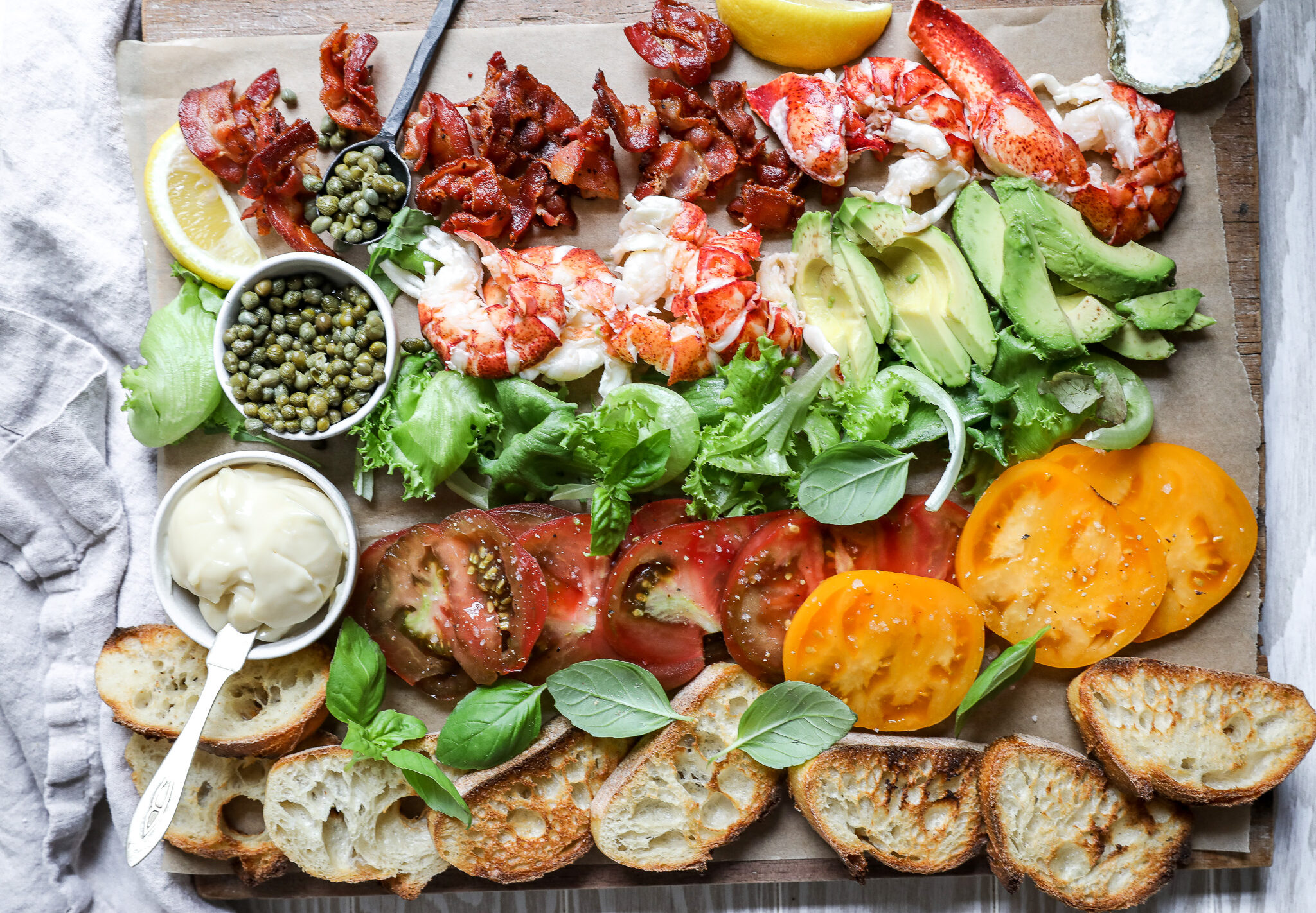A lobster bacon lettuce and tomato sandwich board