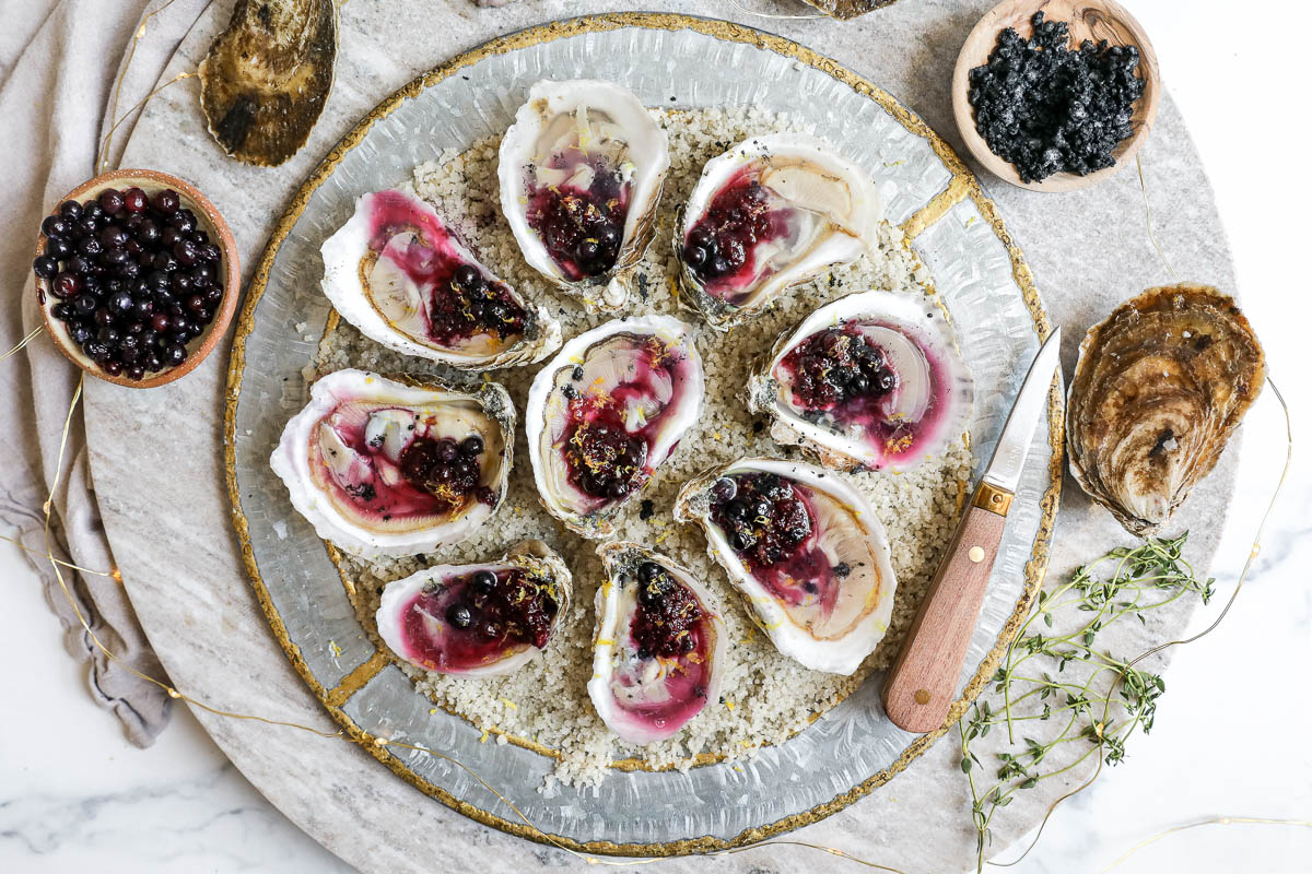 An image of an oyster plattter with wild blueberries