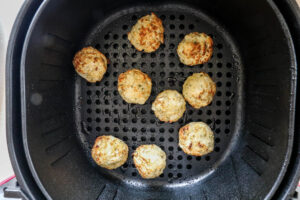 An image of air fried crab cakes in the air fryer.