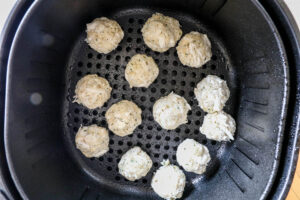 An overhead image of crab cakes in the air fryer.