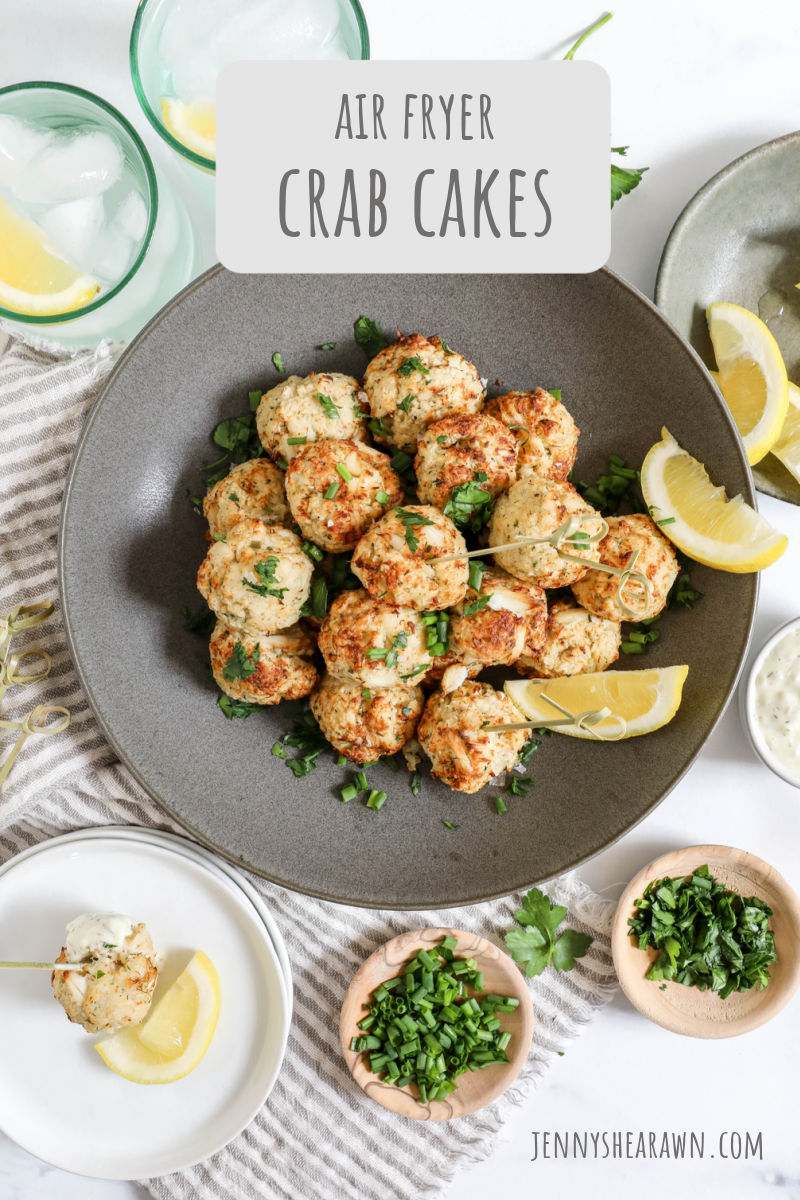 A recipe for air fryer crab cakes. The crab cakes are pictured in a grey bowl with lemon wedges. 
