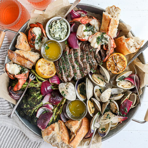 A surf and turf platter on a white table