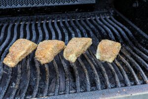 An image of blackened grouper on the grill.