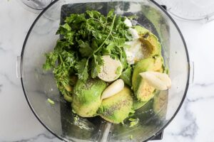 Ingredients for avocado crema in a food processor
