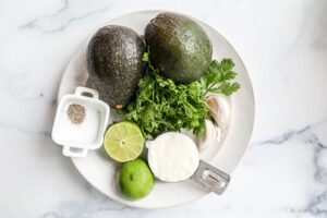 Avocado crema ingredients on a white plate