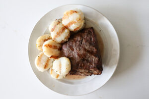 An image of steak and scallops.