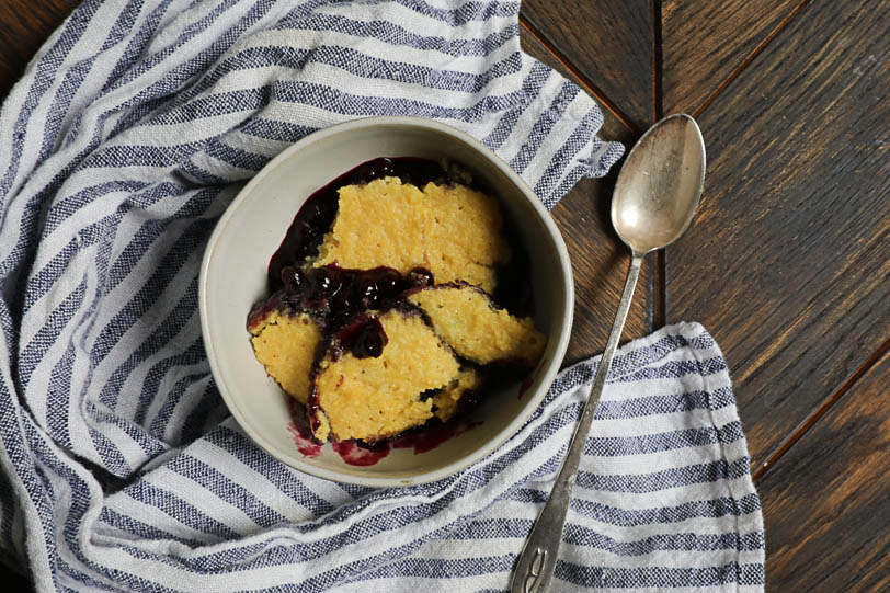 An overhead image of a slow cooker wild blueberry cobbler.