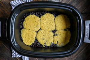 An image of a wild blueberry cobbler in the slowcooker.