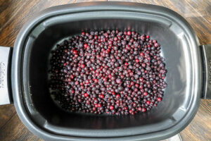 An image of wild blueberries in a slowcooker.