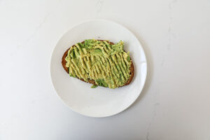 A piece of toast with mashed avocado