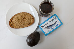 An overhead image of ingredients to make sardine avocado toast