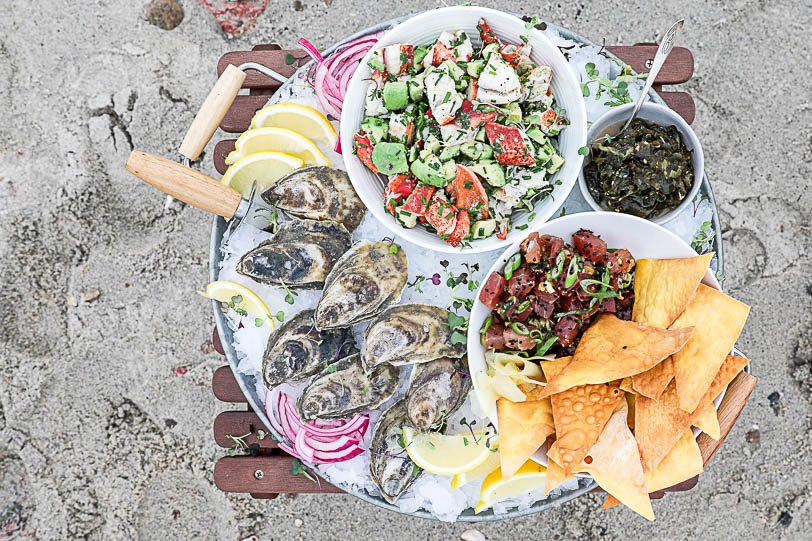 An image of an oyster platter with lobster salad and tuna tartare