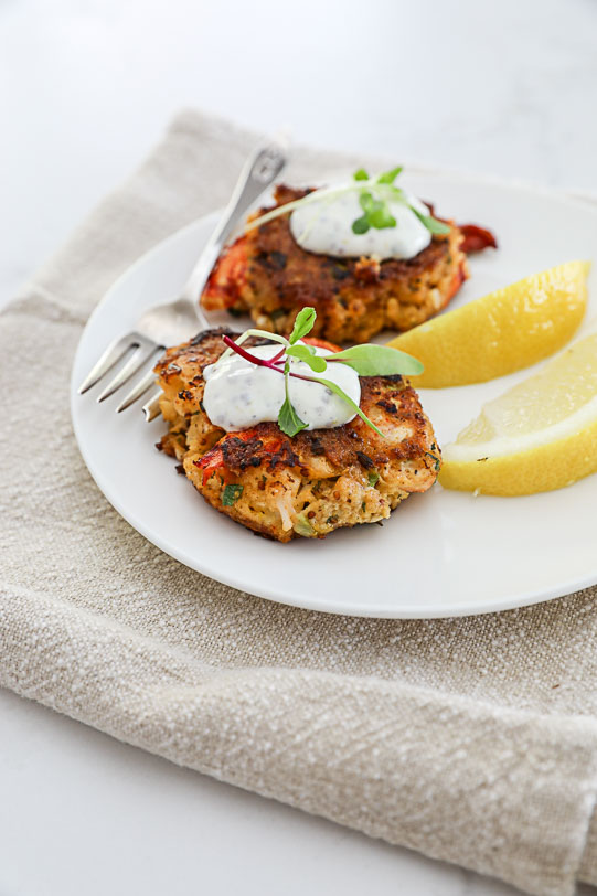 An image of lobster cakes with mustard sauce. 