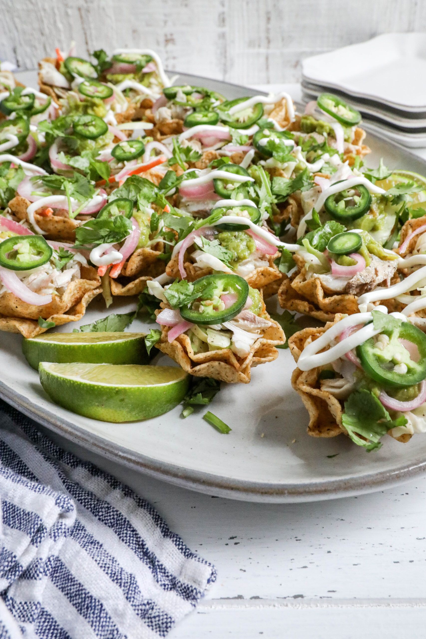 A close-up image of fish taco bites on a large oblong white plate. 