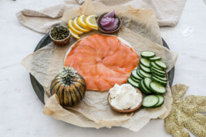 An image of a salmon seacuterie board being assembled. 