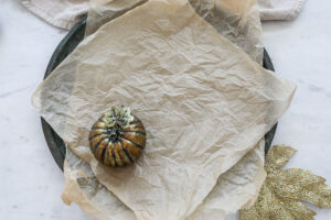 An image of a platter with a gold pumpkin.