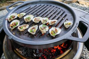 An image of oysters grilling