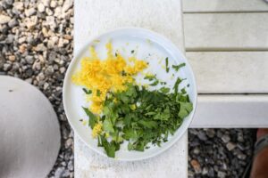 An image of lemon zest and chopped parsley.