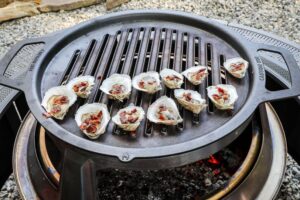 An image of oysters on the half shelling grilling.