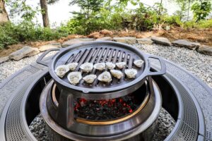 An image of oysters grilling