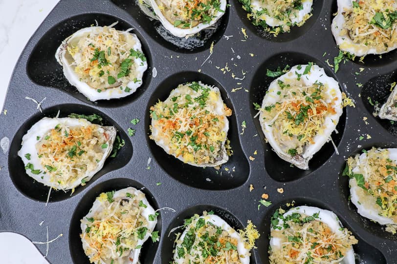 A close-up image of roasted oysters. 