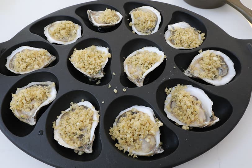 An image of oysters topped with breadcrumbs. 