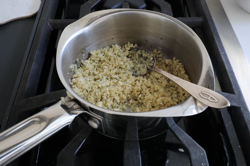 An image of breadcrumbs in a pot with butter. 