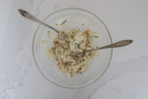 An image of a bowl of crabmeat filling for jalapenos. 