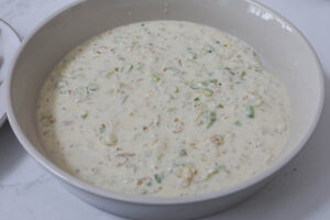 An image of a cream sauce with scallions.