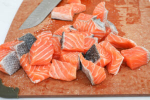 An image of salmon but into bite sized pieces.